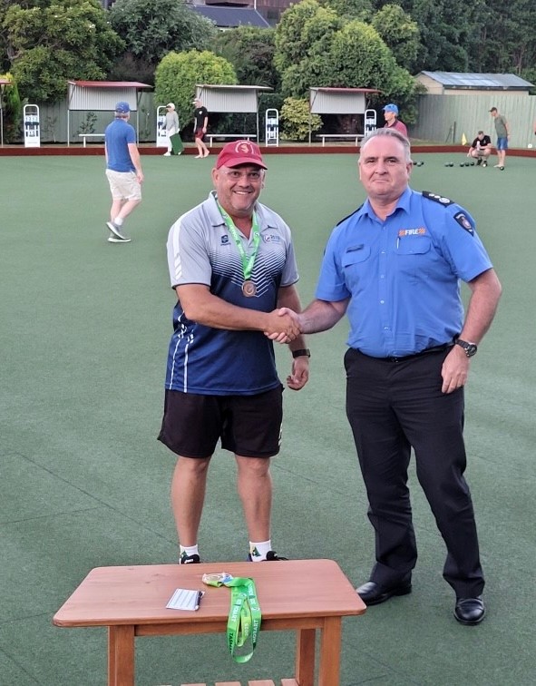 James receiving his medal for lawn bowls